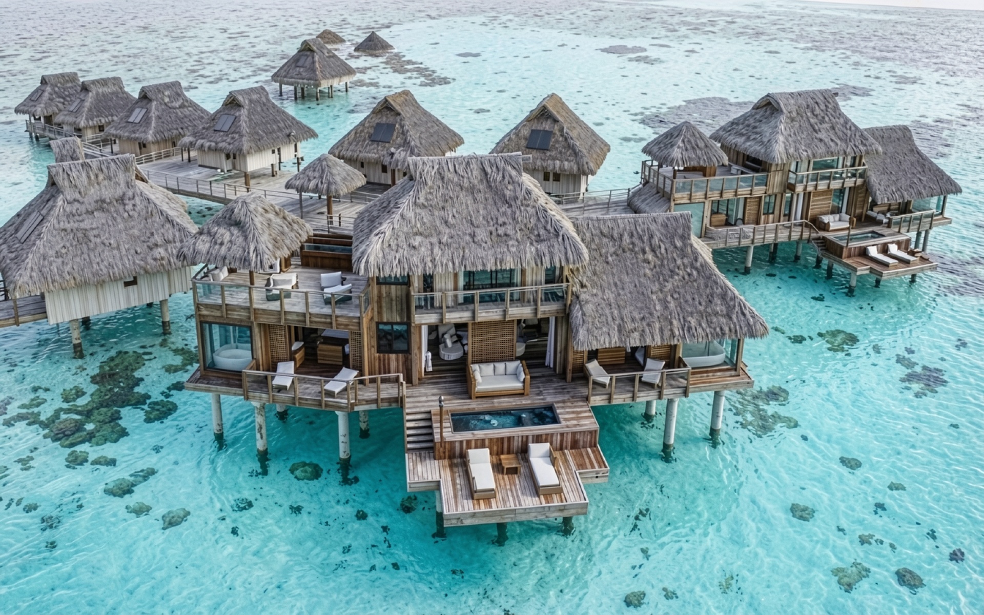 Тропические виллы с соломенными крышами в бирюзовом океане